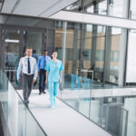 Doctors and nurse walking in corridor at hospital